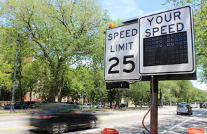 Digital speed sign with cars passing. Links to Enforcing Traffic Laws page.