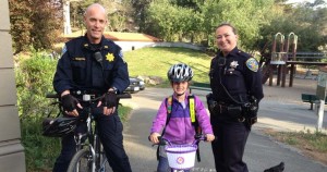 San Francisco Police Officers with a young girl riding bikes,